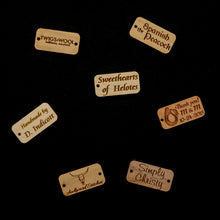 Load image into Gallery viewer, A variety of 1" x .5" custom laser engraved tags cut from hardwoods. Tags can be used for product branding, packaging, or gift bags.