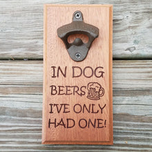 Load image into Gallery viewer, Hardwood bottle opener measuring 4&quot; x 8&quot;, laser engraved with the text In dog beers I&#39;ve only had one! The bottle opener includes a rare earth magnet to hold bottle caps.
