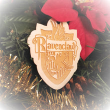 Load image into Gallery viewer, Laser engraved birch Christmas ornament with the Harry Potter Hogwarts House crest of Ravenclaw. Add custom engraved text to the back for a personalized touch.