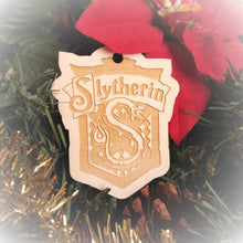 Load image into Gallery viewer, Laser engraved birch Christmas ornament with the Harry Potter Hogwarts House crest of Slytherin. Add custom engraved text to the back for a personalized touch.