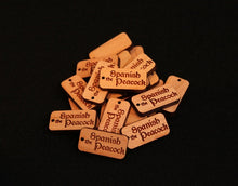 Load image into Gallery viewer, 1" x .5" custom laser engraved tags cut from hardwoods. Tags can be used for product branding, packaging, or gift bags.