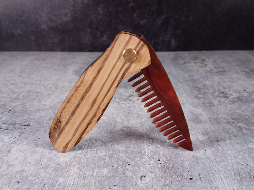Folding tactical beard comb featuring a zebrawood handle and a tortoise shell acrylic blade