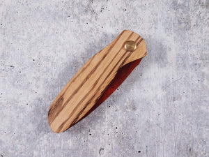 Folding tactical beard comb featuring a zebrawood handle and a tortoise shell acrylic blade