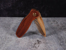 Load image into Gallery viewer, Folding tactical beard comb featuring a yellowheart handle laser engraved with a stipple design, and a bamboo ply blade
