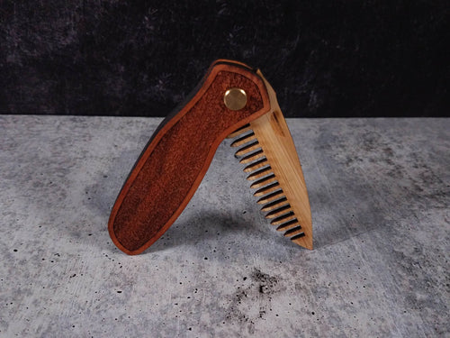Folding tactical beard comb featuring a yellowheart handle laser engraved with a stipple design, and a bamboo ply blade