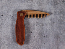 Load image into Gallery viewer, Folding tactical beard comb featuring a yellowheart handle laser engraved with a stipple design, and a bamboo ply blade
