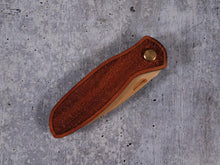 Load image into Gallery viewer, Folding tactical beard comb featuring a yellowheart handle laser engraved with a stipple design, and a bamboo ply blade
