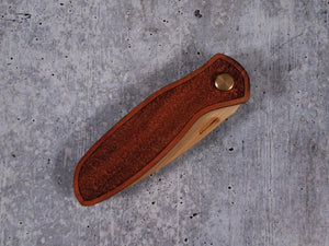 Folding tactical beard comb featuring a yellowheart handle laser engraved with a stipple design, and a bamboo ply blade