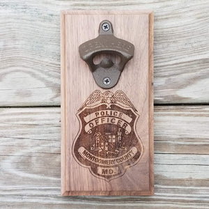 Custom laser engraved hardwood bottle opener measuring 4" x 8". This example shows the Montgomery County MD police officer's badge. The bottle opener includes a rare earth magnet to hold bottle caps.