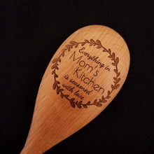Load image into Gallery viewer, Customizable beech wood spoon laser engraved with Everything in Mom&#39;s Kitchen is Seasoned with Love inside a rustic wreath
