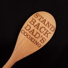 Load image into Gallery viewer, Customizable beech wood spoon laser engraved with Stand Back Dad&#39;s Cooking
