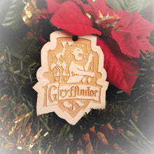 Load image into Gallery viewer, Laser engraved birch Christmas ornament with the Harry Potter Hogwarts House crest of Gryffindor.
