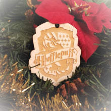 Load image into Gallery viewer, Laser engraved birch Christmas ornament with the Harry Potter Hogwarts House crest of Hufflepuff.
