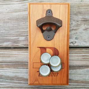 Hardwood bottle opener measuring 4" x 8", laser engraved with a custom monogram and year. The bottle opener includes a rare earth magnet to hold bottle caps.